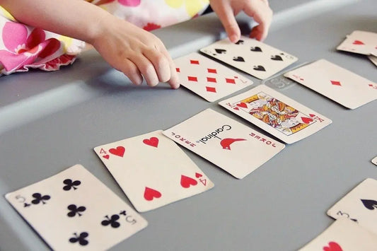Playing cards in a row during a trading card game enhancing critical thinking skills.