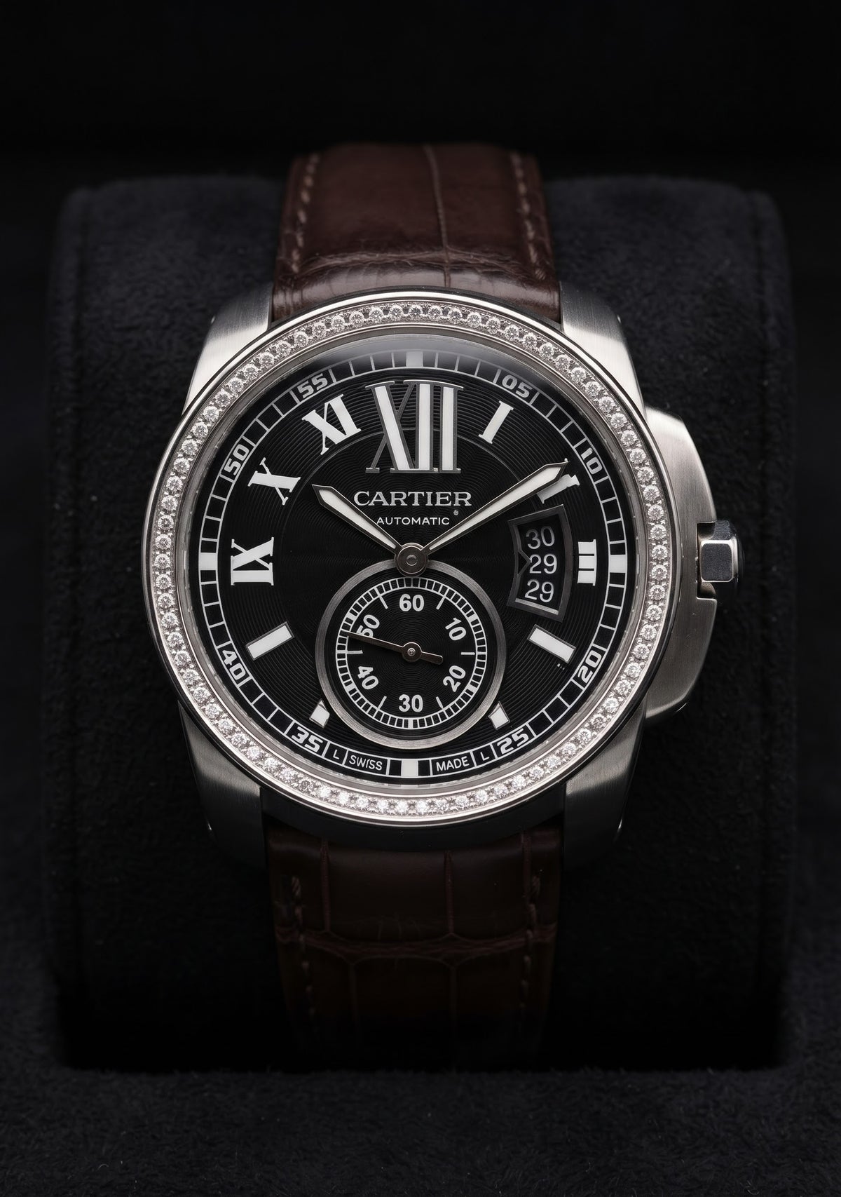 Cartier Calibre style watch with black dial, diamond-set bezel and brown strap
